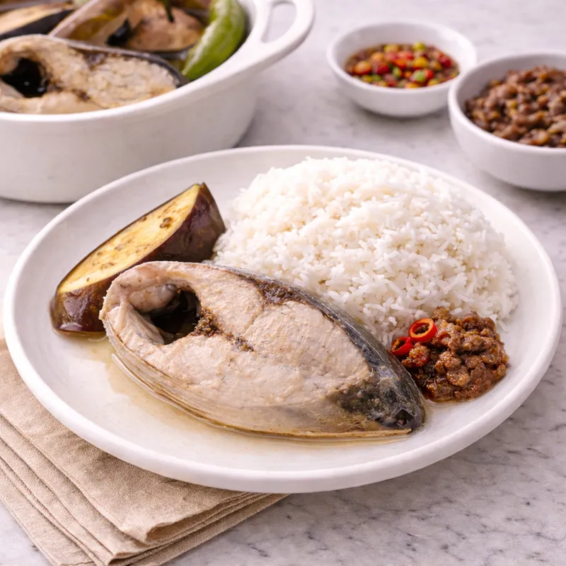 a serving of paksiw na bangus with eggplant and bagoong with white rice