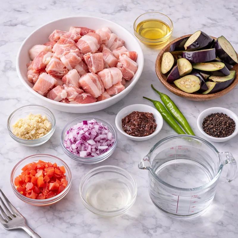 pork binagoongan ingredients laid out on a marble counter