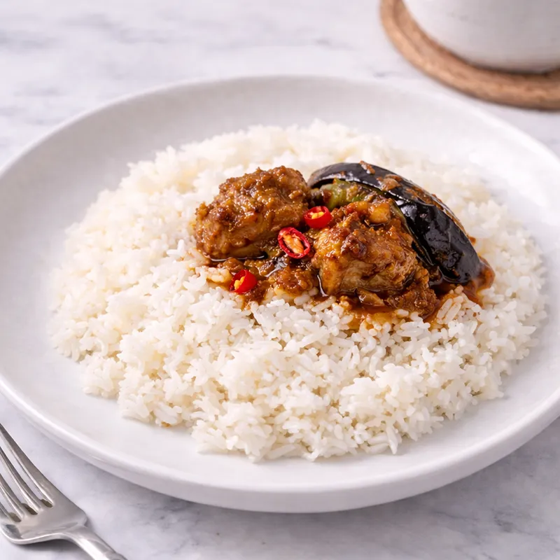 a serving of white rice with pork binagoongan on top